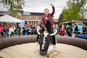 Rebecca Chopp, former Chancellor of the University of Denver, riding a mechanical bull