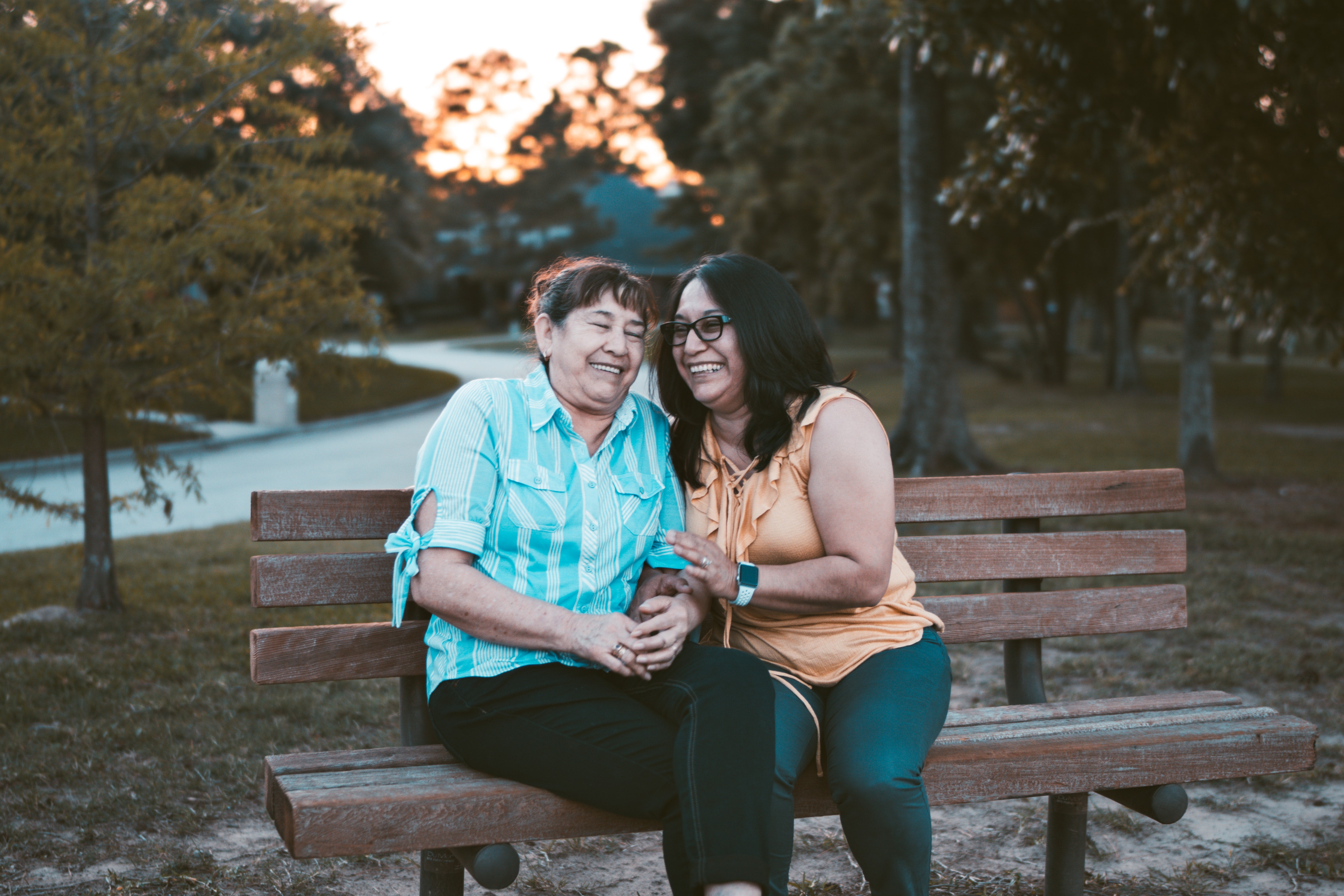two people on a bench smiling