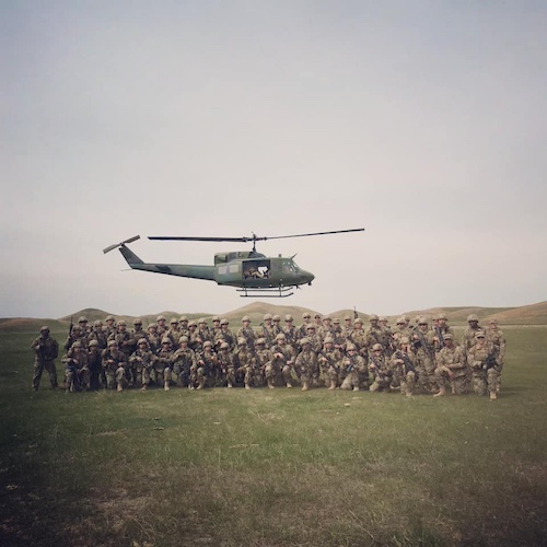 Caleb Smith and his squad with a helicopter