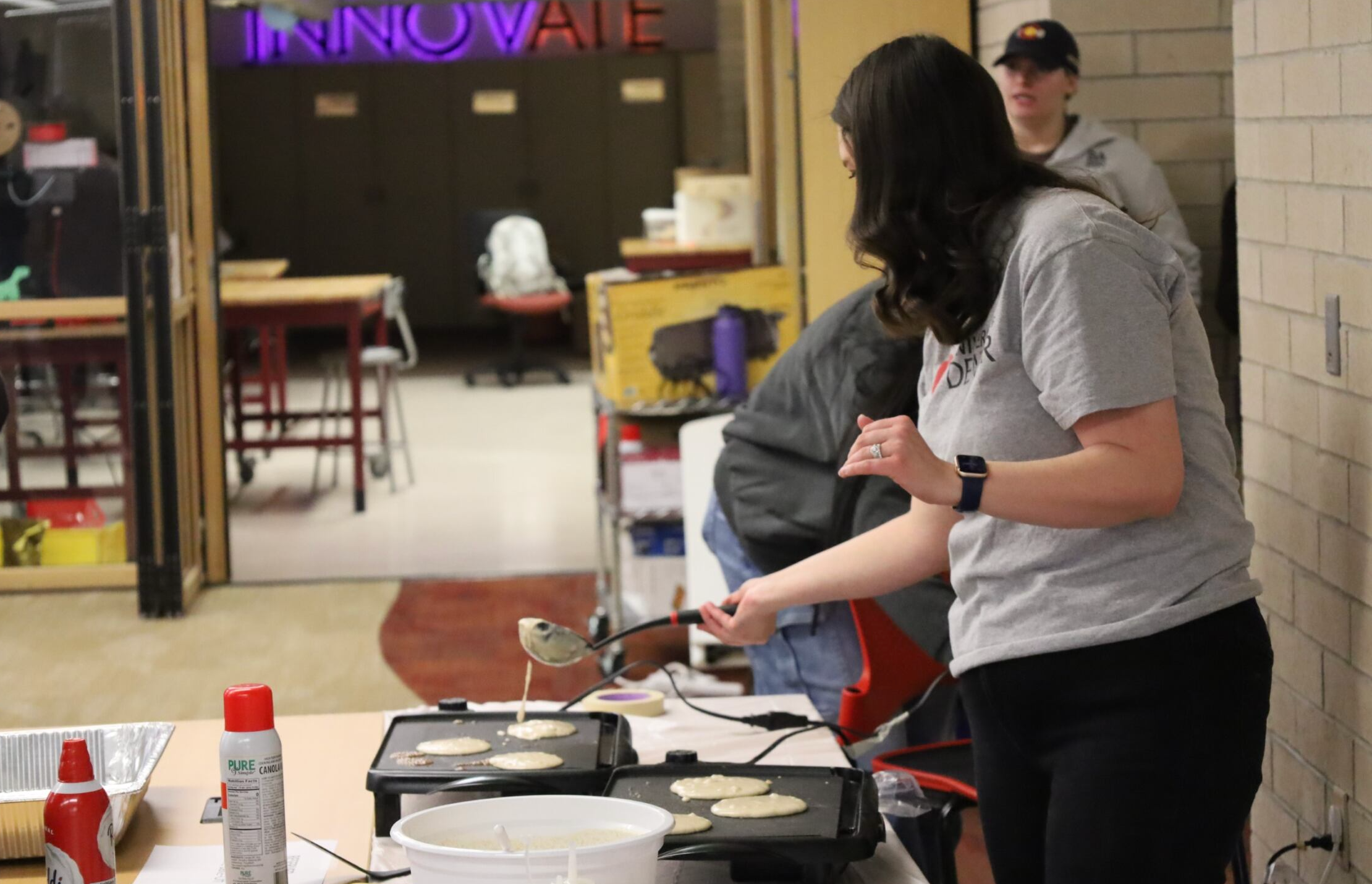 Dr. Breigh Roszelle serving pancakes to students
