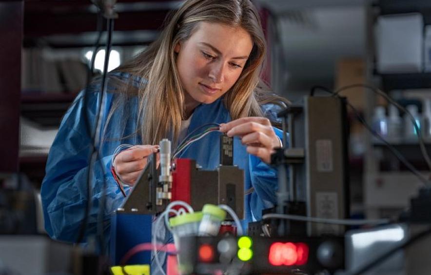 Woman in a lab working with electrical wires