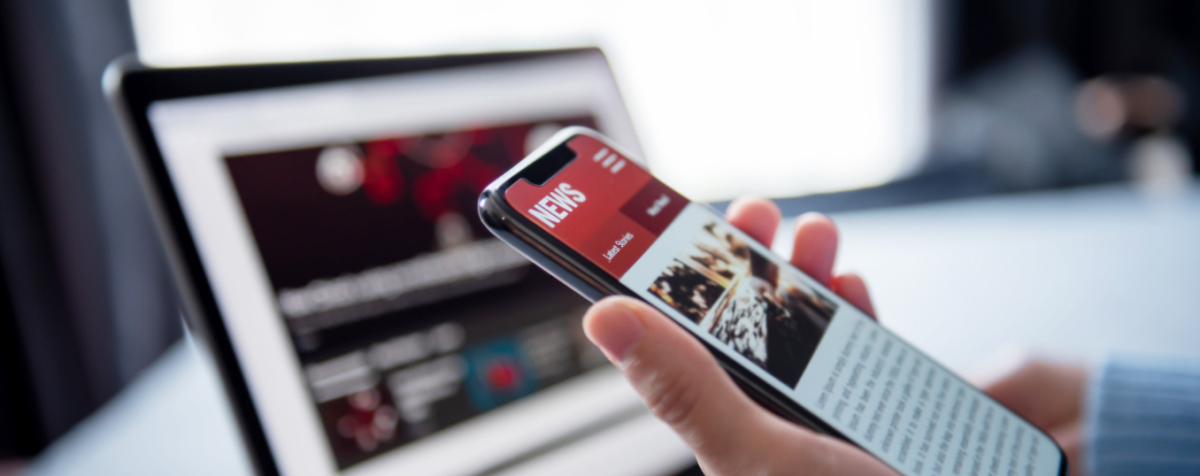 image of phone and computer with headlines on their screens