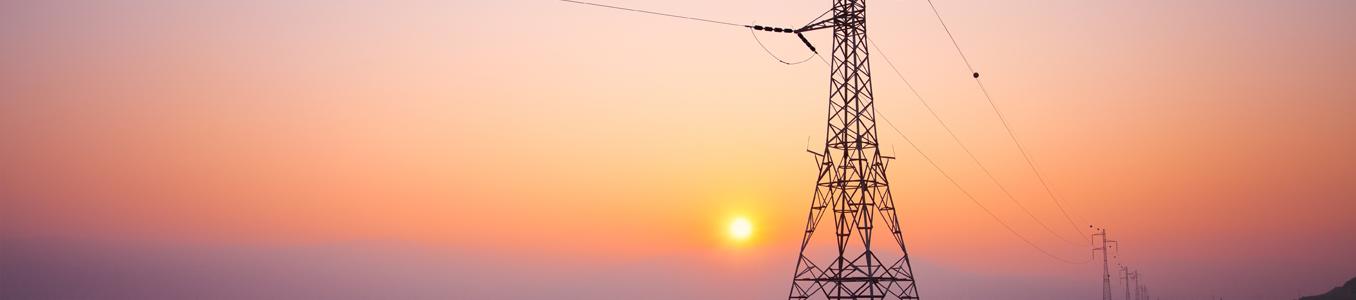 power lines in front of a sunset