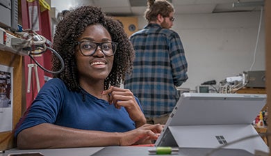 student on laptop in lab